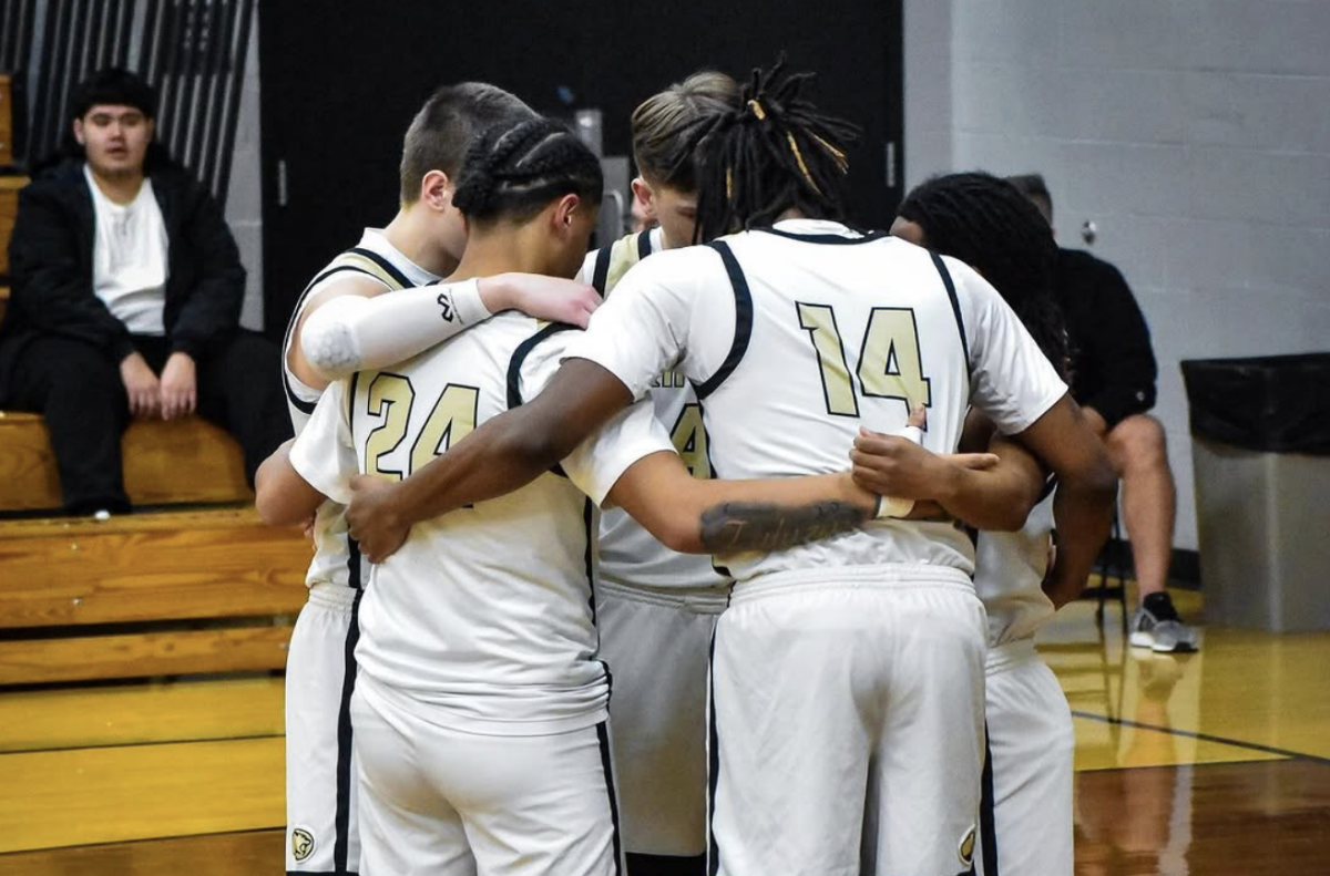 The GHS Boys Basketball team huddles moments before the game starts against Whiting. 